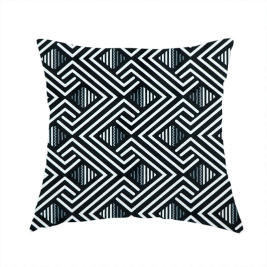 The fabric used to create this handmade cushion is a geometric pattern featuring a repeating labyrinthine or Greek key-inspired design. The fabric has a high-contrast black and white colour scheme, with white interlocking lines forming diamond shapes and diagonal pathways against a deep black background.