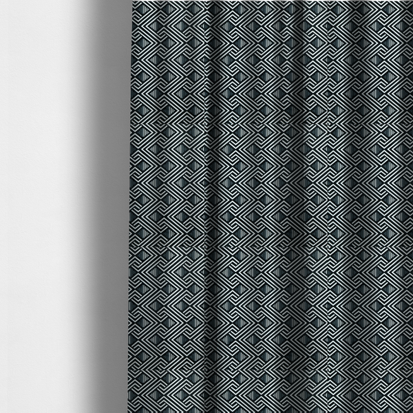 The fabric used to create these made-to-measure curtains is a geometric pattern featuring a repeating labyrinthine or Greek key-inspired design. The fabric has a high-contrast black and white colour scheme, with white interlocking lines forming diamond shapes and diagonal pathways against a deep black background.