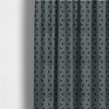 The fabric used to create these made-to-measure curtains is a geometric pattern featuring a repeating labyrinthine or Greek key-inspired design. The fabric has a high-contrast black and white colour scheme, with white interlocking lines forming diamond shapes and diagonal pathways against a deep black background.