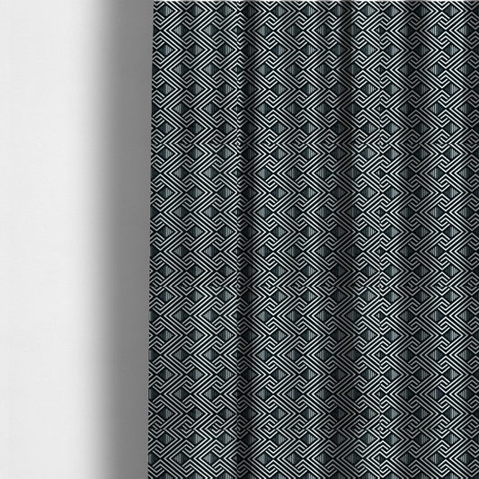 The fabric used to create these made-to-measure curtains is a geometric pattern featuring a repeating labyrinthine or Greek key-inspired design. The fabric has a high-contrast black and white colour scheme, with white interlocking lines forming diamond shapes and diagonal pathways against a deep black background.
