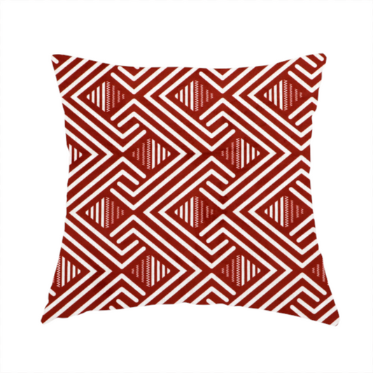 The fabric used to create this handmade cushion is a bold geometric pattern featuring an interlocking labyrinth or fretwork design. The fabric is set in a striking terracotta red and cream colour palette, where crisp white lines weave together to form diagonal chains and diamond shapes against a rich, earthy red background.