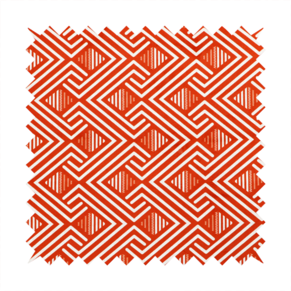 A vibrant geometric pattern with a repeating labyrinth or fretwork motif. The fabric is designed in a high-energy orange and white colour palette, with crisp white interlocking lines creating diagonal paths and diamond shapes against a bright, warm orange background.