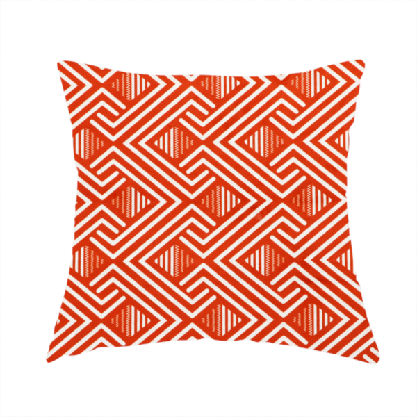 The fabric used to create this handmade cushion is a vibrant geometric pattern with a repeating labyrinth or fretwork motif. The fabric is designed in a high-energy orange and white colour palette, with crisp white interlocking lines creating diagonal paths and diamond shapes against a bright, warm orange background.