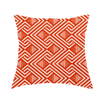 The fabric used to create this handmade cushion is a vibrant geometric pattern with a repeating labyrinth or fretwork motif. The fabric is designed in a high-energy orange and white colour palette, with crisp white interlocking lines creating diagonal paths and diamond shapes against a bright, warm orange background.