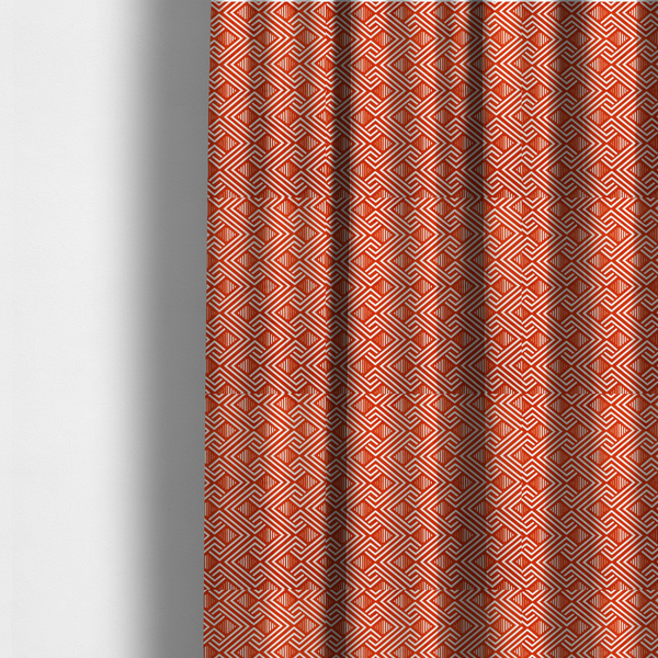 The fabric used to create these made-to-measure curtains is a vibrant geometric pattern with a repeating labyrinth or fretwork motif. The fabric is designed in a high-energy orange and white colour palette, with crisp white interlocking lines creating diagonal paths and diamond shapes against a bright, warm orange background.