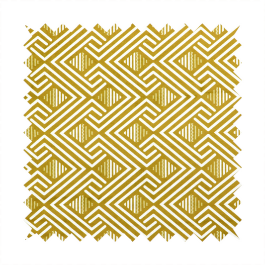 A dynamic geometric pattern with a repeating labyrinth or fretwork motif. The fabric showcases a sophisticated mustard yellow and white colour palette, with crisp white interlocking lines creating diagonal chains and diamond shapes against a warm, golden-yellow background.