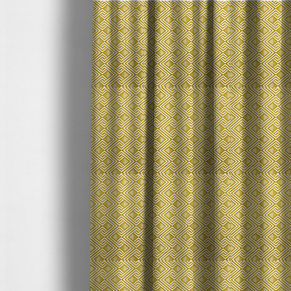 The fabric used to create these made-to-measure curtains is a dynamic geometric pattern with a repeating labyrinth or fretwork motif. The fabric showcases a sophisticated mustard yellow and white colour palette, with crisp white interlocking lines creating diagonal chains and diamond shapes against a warm, golden-yellow background.