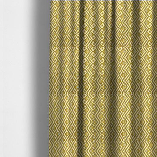 The fabric used to create these made-to-measure curtains is a dynamic geometric pattern with a repeating labyrinth or fretwork motif. The fabric showcases a sophisticated mustard yellow and white colour palette, with crisp white interlocking lines creating diagonal chains and diamond shapes against a warm, golden-yellow background.