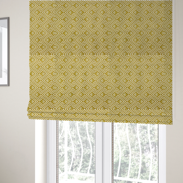 The fabric used to create these Roman blinds is a dynamic geometric pattern with a repeating labyrinth or fretwork motif. The fabric showcases a sophisticated mustard yellow and white colour palette, with crisp white interlocking lines creating diagonal chains and diamond shapes against a warm, golden-yellow background.