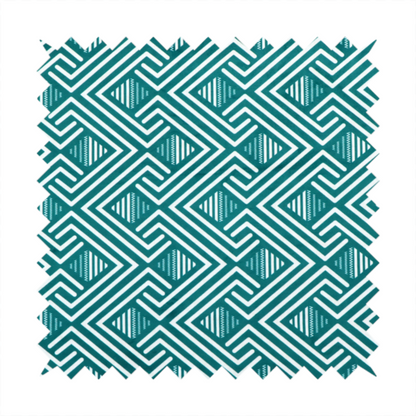 A striking geometric pattern featuring an interlocking labyrinth or fretwork motif. The fabric is set in a refreshing teal and white colour palette, with crisp white lines weaving together to form diagonal chains and diamond shapes against a rich, deep sea-green background.