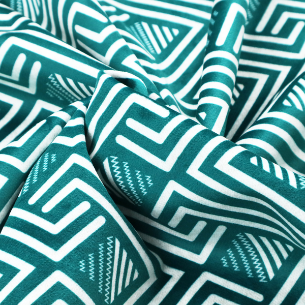 A striking geometric pattern featuring an interlocking labyrinth or fretwork motif. The fabric is set in a refreshing teal and white colour palette, with crisp white lines weaving together to form diagonal chains and diamond shapes against a rich, deep sea-green background.