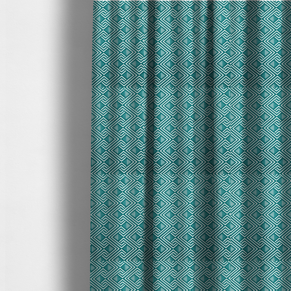 The fabric used to create these made-to-measure curtains is a striking geometric pattern featuring an interlocking labyrinth or fretwork motif. The fabric is set in a refreshing teal and white colour palette, with crisp white lines weaving together to form diagonal chains and diamond shapes against a rich, deep sea-green background.
