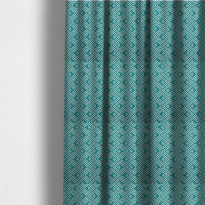 The fabric used to create these made-to-measure curtains is a striking geometric pattern featuring an interlocking labyrinth or fretwork motif. The fabric is set in a refreshing teal and white colour palette, with crisp white lines weaving together to form diagonal chains and diamond shapes against a rich, deep sea-green background.