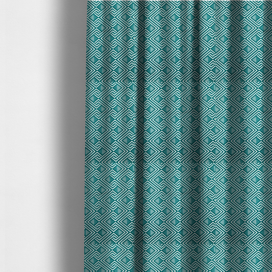 The fabric used to create these made-to-measure curtains is a striking geometric pattern featuring an interlocking labyrinth or fretwork motif. The fabric is set in a refreshing teal and white colour palette, with crisp white lines weaving together to form diagonal chains and diamond shapes against a rich, deep sea-green background.