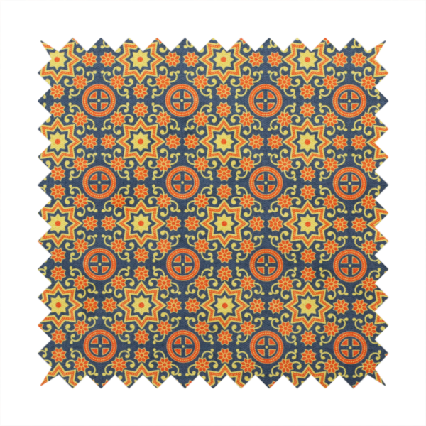 A dense, symmetrical textile pattern featuring a repeating grid of pale yellow eight-pointed stars and orange circular medallions. The motifs are interconnected by delicate orange scrolling vines and tiny floral accents, set against a deep navy blue background. The colour palette consists of mustard yellow, burnt orange, and indigo.