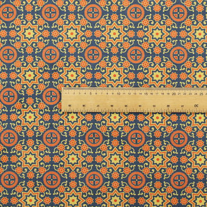 A dense, symmetrical textile pattern featuring a repeating grid of pale yellow eight-pointed stars and orange circular medallions. The motifs are interconnected by delicate orange scrolling vines and tiny floral accents, set against a deep navy blue background. The colour palette consists of mustard yellow, burnt orange, and indigo.