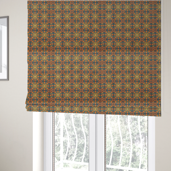 The fabric used to create these Roman blinds is a dense, symmetrical textile pattern featuring a repeating grid of pale yellow eight-pointed stars and orange circular medallions. The motifs are interconnected by delicate orange scrolling vines and tiny floral accents, set against a deep navy blue background. The colour palette consists of mustard yellow, burnt orange, and indigo.