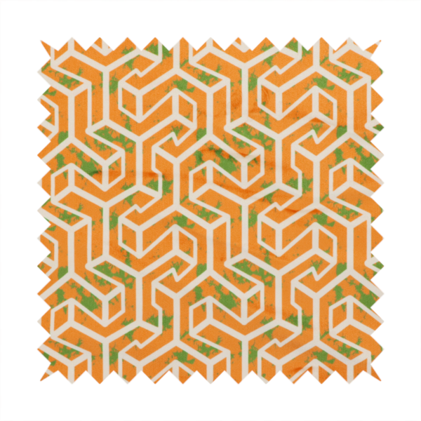 An orange and white textile fabric featuring a repeating, interlocking geometric pattern. The design consists of white outlines that form three-dimensional, maze-like structures or isometric blocks against a vibrant orange background. A textured, green moss-like speckled effect is scattered across the orange spaces, adding an organic contrast to the sharp, structured geometric lines.