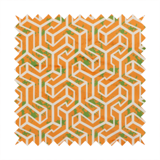 An orange and white textile fabric featuring a repeating, interlocking geometric pattern. The design consists of white outlines that form three-dimensional, maze-like structures or isometric blocks against a vibrant orange background. A textured, green moss-like speckled effect is scattered across the orange spaces, adding an organic contrast to the sharp, structured geometric lines.