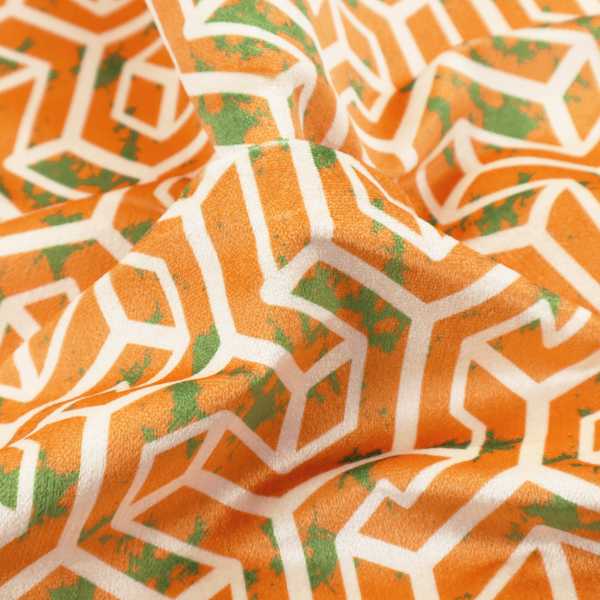 An orange and white textile fabric featuring a repeating, interlocking geometric pattern. The design consists of white outlines that form three-dimensional, maze-like structures or isometric blocks against a vibrant orange background. A textured, green moss-like speckled effect is scattered across the orange spaces, adding an organic contrast to the sharp, structured geometric lines.