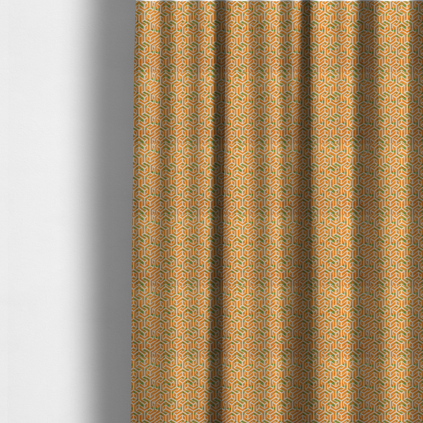 The fabric used to create these made-to-measure curtains is an orange and white textile fabric featuring a repeating, interlocking geometric pattern. The design consists of white outlines that form three-dimensional, maze-like structures or isometric blocks against a vibrant orange background. A textured, green moss-like speckled effect is scattered across the orange spaces, adding an organic contrast to the sharp, structured geometric lines.
