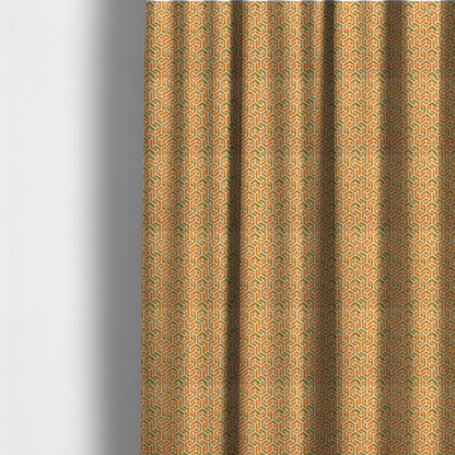 The fabric used to create these made-to-measure curtains is an orange and white textile fabric featuring a repeating, interlocking geometric pattern. The design consists of white outlines that form three-dimensional, maze-like structures or isometric blocks against a vibrant orange background. A textured, green moss-like speckled effect is scattered across the orange spaces, adding an organic contrast to the sharp, structured geometric lines.