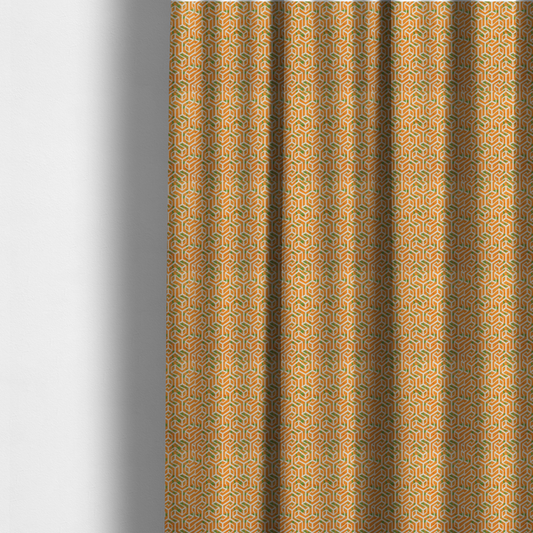 The fabric used to create these made-to-measure curtains is an orange and white textile fabric featuring a repeating, interlocking geometric pattern. The design consists of white outlines that form three-dimensional, maze-like structures or isometric blocks against a vibrant orange background. A textured, green moss-like speckled effect is scattered across the orange spaces, adding an organic contrast to the sharp, structured geometric lines.