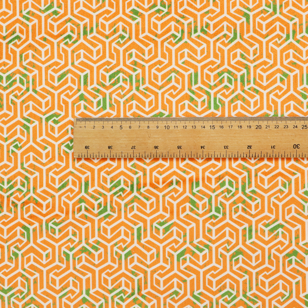 An orange and white textile fabric featuring a smaller, densely repeating interlocking geometric pattern. The design consists of fine white outlines forming complex, three-dimensional isometric block structures on an orange background. Scattered green, moss-like textured speckles are integrated throughout, creating an organic, weathered look against the sharp geometry.