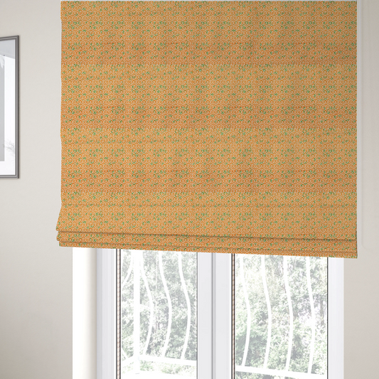 The fabric used to create these Roman blinds is a orange and white textile fabric featuring a smaller, densely repeating interlocking geometric pattern. The design consists of fine white outlines forming complex, three-dimensional isometric block structures on an orange background. Scattered green, moss-like textured speckles are integrated throughout, creating an organic, weathered look against the sharp geometry.