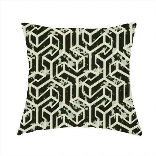 The fabric used to create this handmade cushion is a black and off-white textile fabric featuring a repeating, interlocking geometric pattern. The design consists of off-white outlines that form three-dimensional, isometric maze-like structures against a solid black background. Distressed, pale green speckled textures are subtly integrated into the background spaces, giving the sharp, structured design a weathered, organic touch.