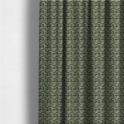 The fabric used to create these made-to-measure curtains is a black and off-white textile fabric featuring a repeating, interlocking geometric pattern. The design consists of off-white outlines that form three-dimensional, isometric maze-like structures against a solid black background. Distressed, pale green speckled textures are subtly integrated into the background spaces, giving the sharp, structured design a weathered, organic touch.