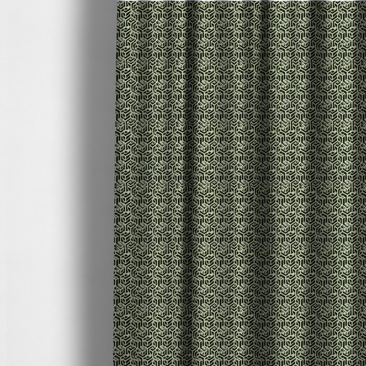 The fabric used to create these made-to-measure curtains is a black and off-white textile fabric featuring a repeating, interlocking geometric pattern. The design consists of off-white outlines that form three-dimensional, isometric maze-like structures against a solid black background. Distressed, pale green speckled textures are subtly integrated into the background spaces, giving the sharp, structured design a weathered, organic touch.