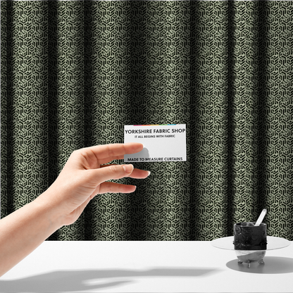The fabric used to create these made-to-measure curtains is a black and off-white textile fabric featuring a repeating, interlocking geometric pattern. The design consists of off-white outlines that form three-dimensional, isometric maze-like structures against a solid black background. Distressed, pale green speckled textures are subtly integrated into the background spaces, giving the sharp, structured design a weathered, organic touch.