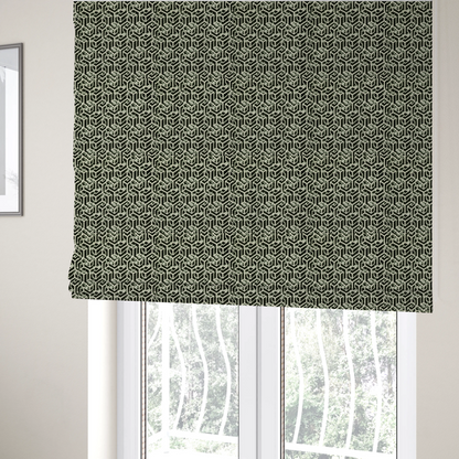 The fabric used to create these Roman blinds is a black and off-white textile fabric featuring a repeating, interlocking geometric pattern. The design consists of off-white outlines that form three-dimensional, isometric maze-like structures against a solid black background. Distressed, pale green speckled textures are subtly integrated into the background spaces, giving the sharp, structured design a weathered, organic touch.