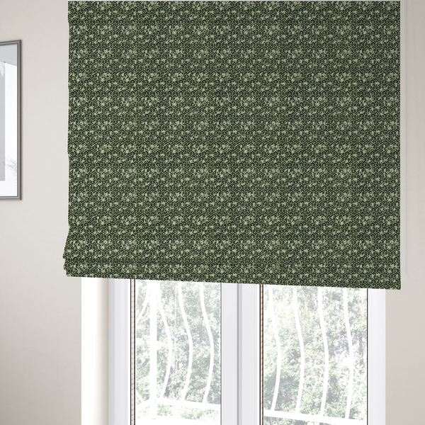 The fabric used to create these Roman blinds is a black and off-white textile fabric featuring a small-scale, densely repeating interlocking geometric pattern. Fine off-white outlines construct complex, three-dimensional isometric block formations against a solid black background. Pale green, distressed textured speckles are integrated throughout, creating a weathered, organic contrast to the sharp geometric structure.