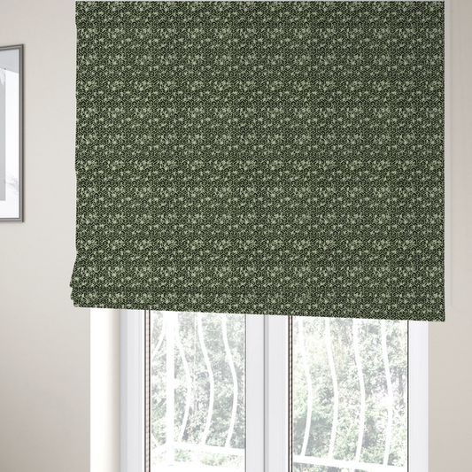 The fabric used to create these Roman blinds is a black and off-white textile fabric featuring a small-scale, densely repeating interlocking geometric pattern. Fine off-white outlines construct complex, three-dimensional isometric block formations against a solid black background. Pale green, distressed textured speckles are integrated throughout, creating a weathered, organic contrast to the sharp geometric structure.