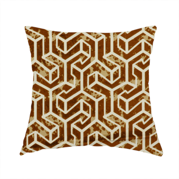 The fabric used to create this handmade cushion is a brown and cream textile fabric featuring a repeating, interlocking geometric pattern. The design consists of cream-colored outlines forming three-dimensional, isometric maze-like structures against a warm, dark brown background. Lightly distressed, tan-speckled textures are subtly scattered throughout the brown spaces, adding a weathered, organic feel to the structured, geometric design.
