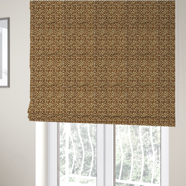 The fabric used to create these Roman blinds is a brown and cream textile fabric featuring a repeating, interlocking geometric pattern. The design consists of cream-colored outlines forming three-dimensional, isometric maze-like structures against a warm, dark brown background. Lightly distressed, tan-speckled textures are subtly scattered throughout the brown spaces, adding a weathered, organic feel to the structured, geometric design.