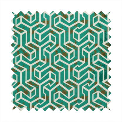 A teal and off-white textile fabric featuring a repeating, interlocking geometric pattern. The design consists of off-white outlines forming three-dimensional, isometric maze-like structures against a deep teal background. Distressed, brown speckled textures are subtly scattered throughout the teal spaces, giving the structured, geometric layout a weathered, organic touch.