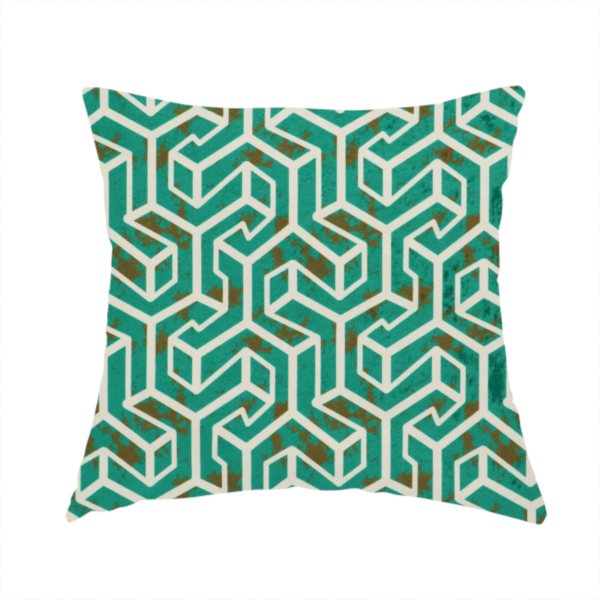 The fabric used to create this handmade cushion is a teal and off-white textile fabric featuring a repeating, interlocking geometric pattern. The design consists of off-white outlines forming three-dimensional, isometric maze-like structures against a deep teal background. Distressed, brown speckled textures are subtly scattered throughout the teal spaces, giving the structured, geometric layout a weathered, organic touch.