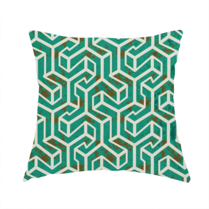 The fabric used to create this handmade cushion is a teal and off-white textile fabric featuring a repeating, interlocking geometric pattern. The design consists of off-white outlines forming three-dimensional, isometric maze-like structures against a deep teal background. Distressed, brown speckled textures are subtly scattered throughout the teal spaces, giving the structured, geometric layout a weathered, organic touch.