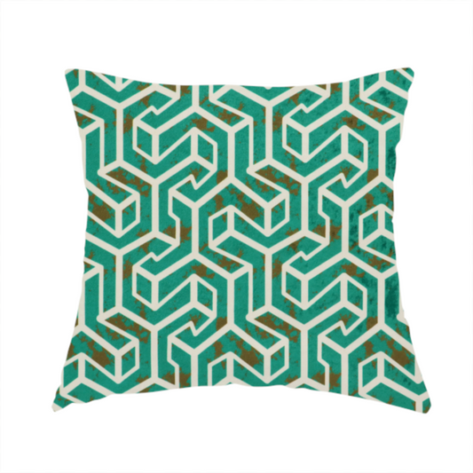 The fabric used to create this handmade cushion is a teal and off-white textile fabric featuring a repeating, interlocking geometric pattern. The design consists of off-white outlines forming three-dimensional, isometric maze-like structures against a deep teal background. Distressed, brown speckled textures are subtly scattered throughout the teal spaces, giving the structured, geometric layout a weathered, organic touch.