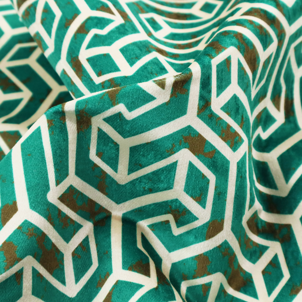 A teal and off-white textile fabric featuring a repeating, interlocking geometric pattern. The design consists of off-white outlines forming three-dimensional, isometric maze-like structures against a deep teal background. Distressed, brown speckled textures are subtly scattered throughout the teal spaces, giving the structured, geometric layout a weathered, organic touch.