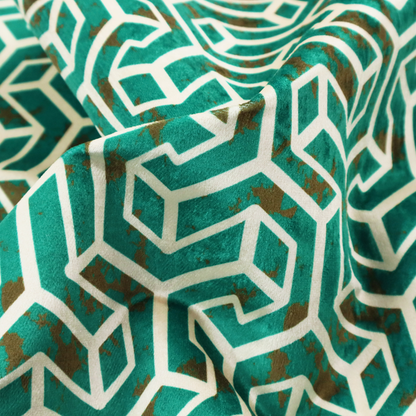 A teal and off-white textile fabric featuring a repeating, interlocking geometric pattern. The design consists of off-white outlines forming three-dimensional, isometric maze-like structures against a deep teal background. Distressed, brown speckled textures are subtly scattered throughout the teal spaces, giving the structured, geometric layout a weathered, organic touch.