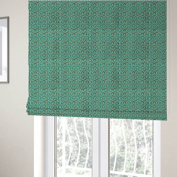 The fabric used to create these Roman blinds is a teal and off-white textile fabric featuring a repeating, interlocking geometric pattern. The design consists of off-white outlines forming three-dimensional, isometric maze-like structures against a deep teal background. Distressed, brown speckled textures are subtly scattered throughout the teal spaces, giving the structured, geometric layout a weathered, organic touch.