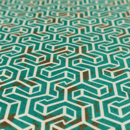 A teal and off-white textile fabric featuring a small-scale, densely repeating interlocking geometric pattern. Fine off-white outlines construct complex, three-dimensional isometric block formations against a deep teal background. Distressed, brown-speckled textures are integrated throughout, creating a weathered, organic contrast to the sharp geometric structure.