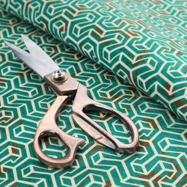 A teal and off-white textile fabric featuring a small-scale, densely repeating interlocking geometric pattern. Fine off-white outlines construct complex, three-dimensional isometric block formations against a deep teal background. Distressed, brown-speckled textures are integrated throughout, creating a weathered, organic contrast to the sharp geometric structure.