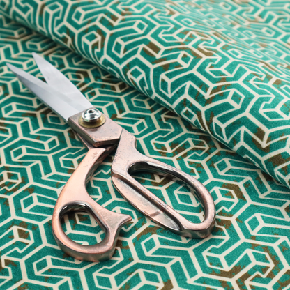 A teal and off-white textile fabric featuring a small-scale, densely repeating interlocking geometric pattern. Fine off-white outlines construct complex, three-dimensional isometric block formations against a deep teal background. Distressed, brown-speckled textures are integrated throughout, creating a weathered, organic contrast to the sharp geometric structure.