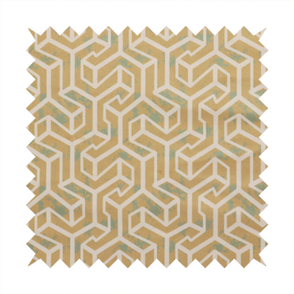 A beige and off-white textile fabric featuring a repeating, interlocking geometric pattern. The design consists of off-white outlines forming three-dimensional, isometric maze-like structures against a warm beige background. Distressed, pale green-blue speckled textures are subtly scattered throughout the beige spaces, giving the structured, geometric layout a weathered, organic touch.