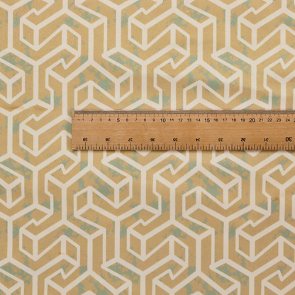 A beige and off-white textile fabric featuring a repeating, interlocking geometric pattern. The design consists of off-white outlines forming three-dimensional, isometric maze-like structures against a warm beige background. Distressed, pale green-blue speckled textures are subtly scattered throughout the beige spaces, giving the structured, geometric layout a weathered, organic touch.